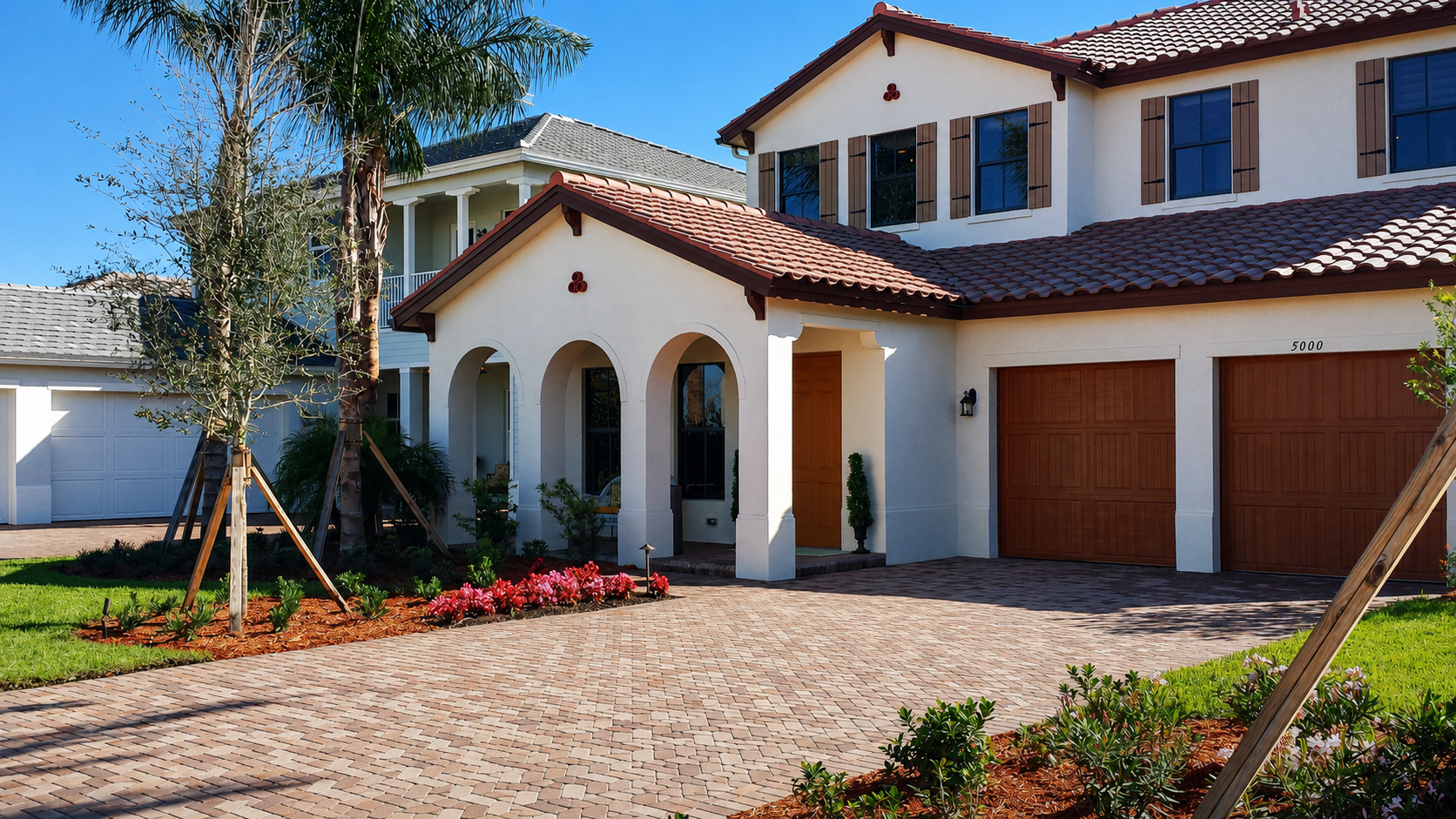 Luxury mansion with palm trees driveway